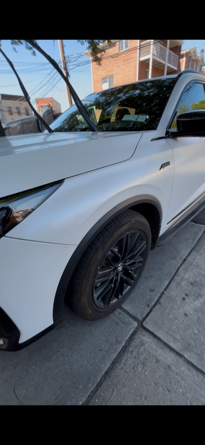 Detailed wheel and glossy paint on a white SUV